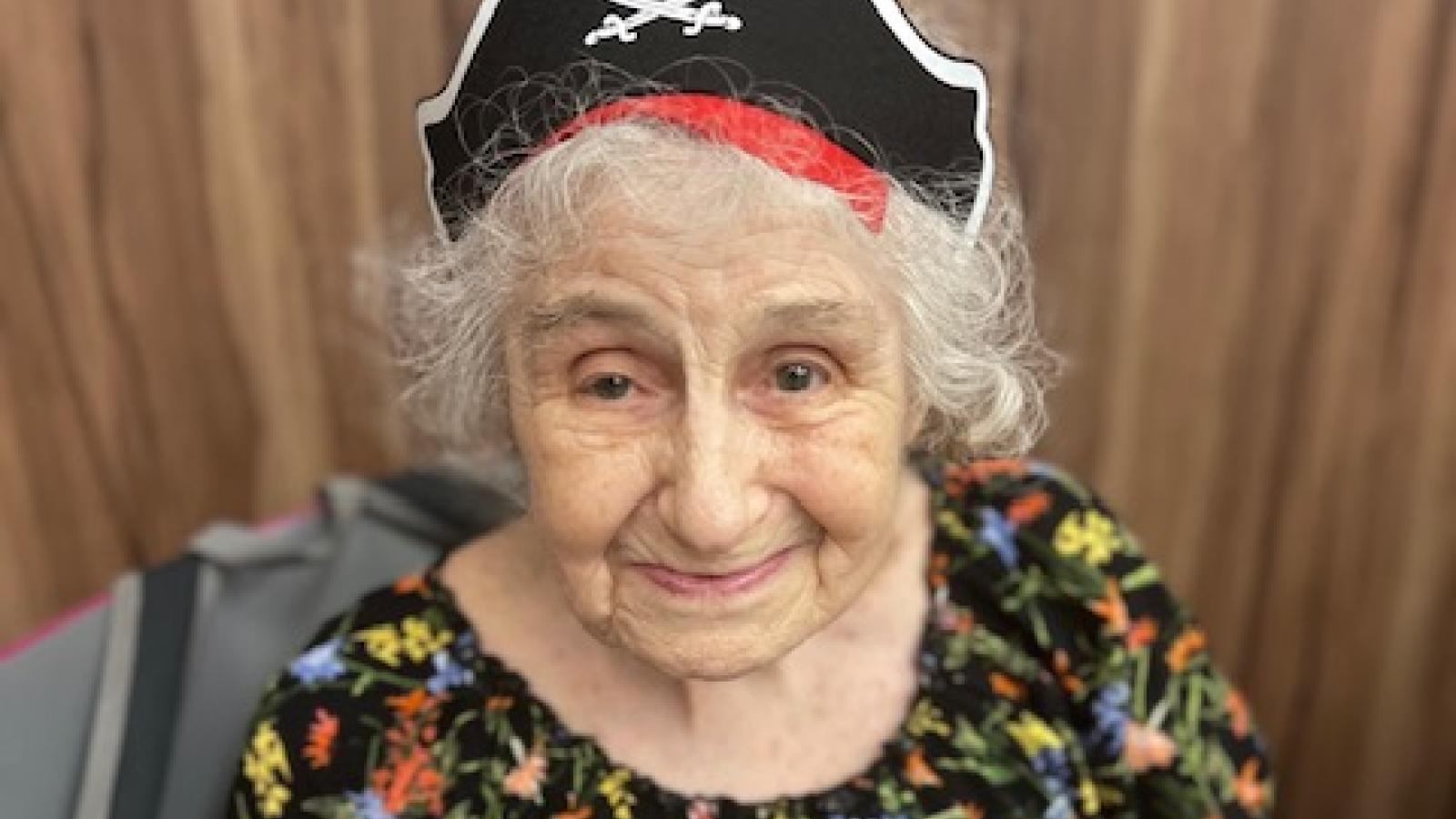 Senior wearing pirate hat posing for photo