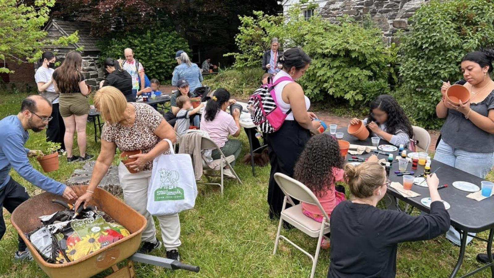 Group of people decorating pottery and planting