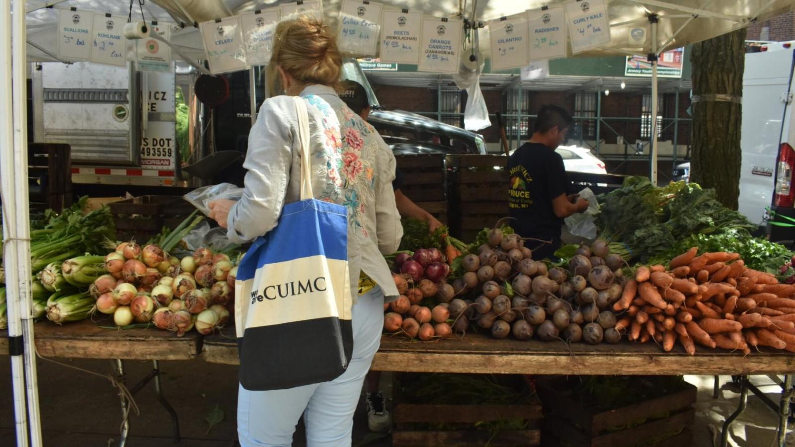 Woman buying vegetables at green market