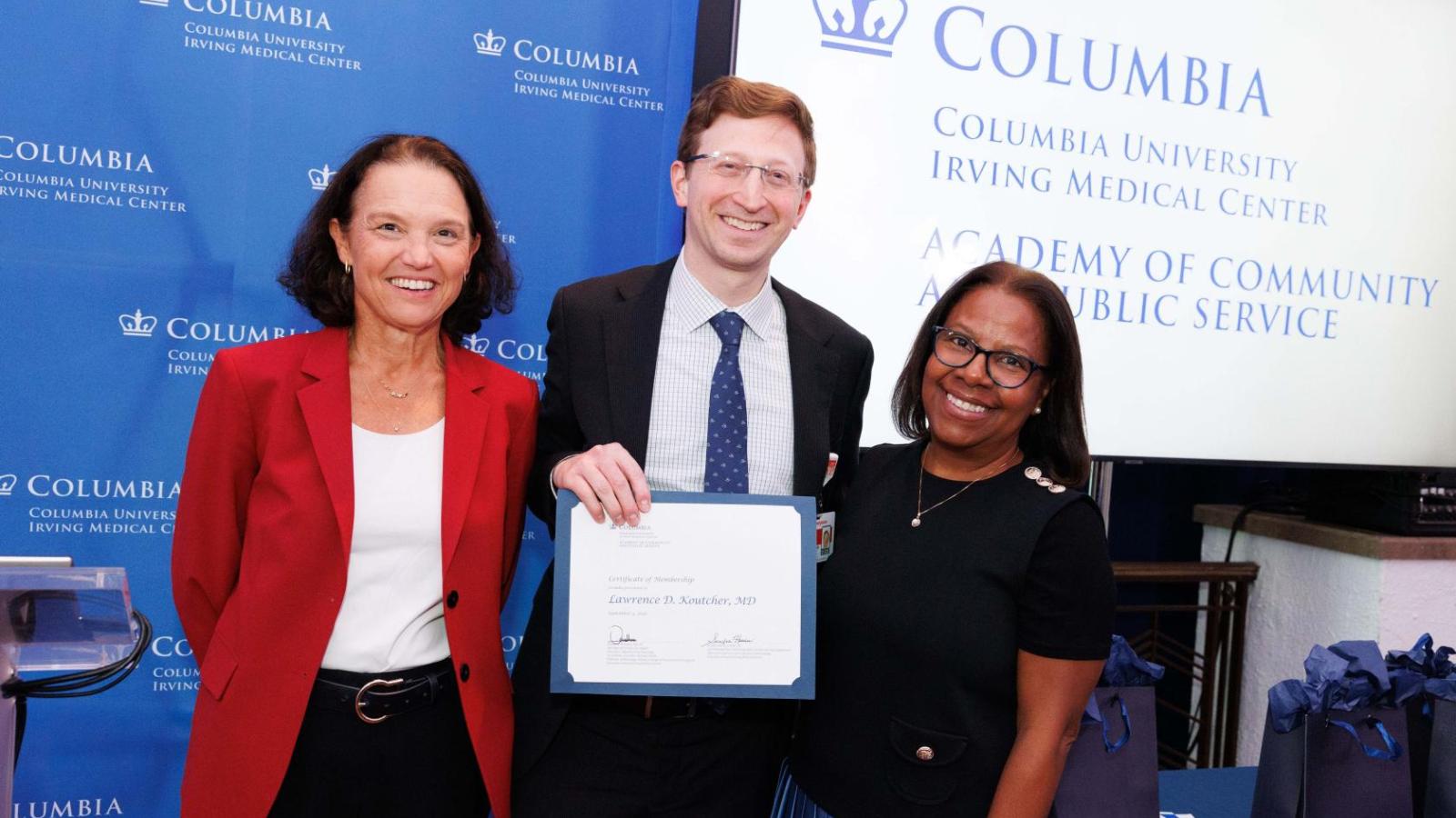 Three people smiling with Columbia University Irving Medical Center logo in the background